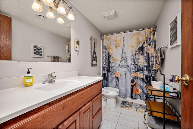 bathroom featuring visible vents, toilet, a textured ceiling, vanity, and tile patterned floors