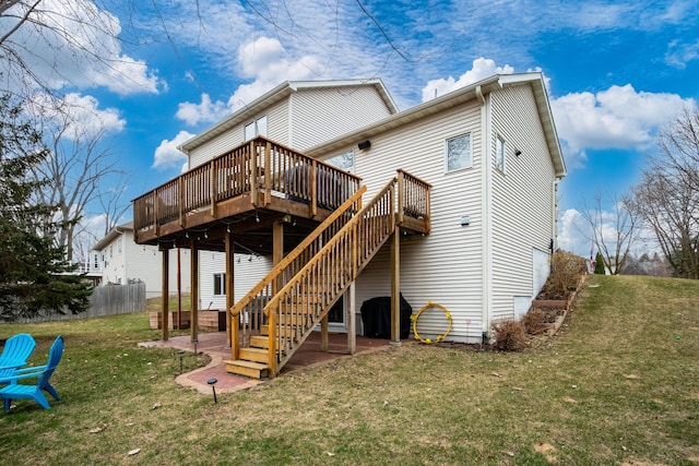 rear view of house with a yard, a patio, fence, stairs, and a deck