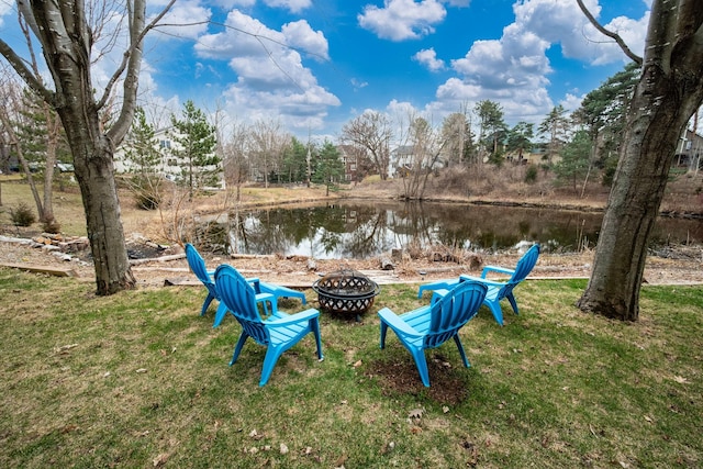 view of yard with a water view and an outdoor fire pit