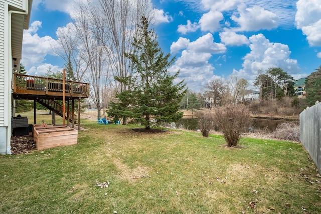 view of yard featuring stairs, a deck, and fence