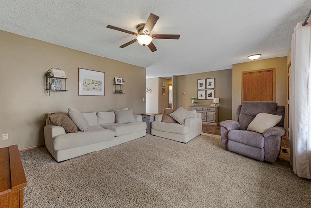 carpeted living room with ceiling fan and a textured ceiling