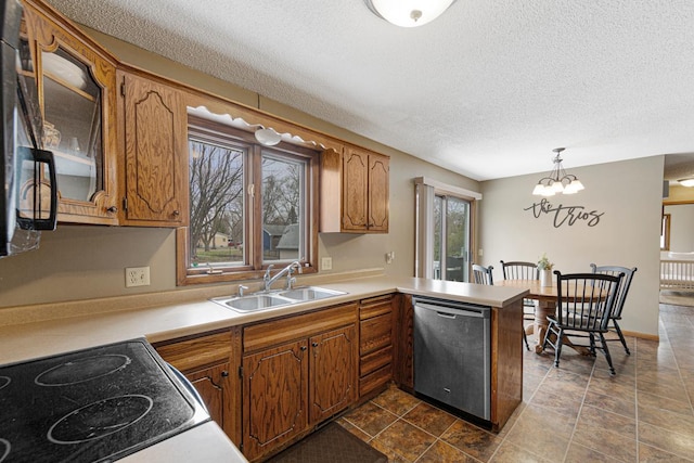 kitchen featuring brown cabinetry, a peninsula, stainless steel dishwasher, and a sink