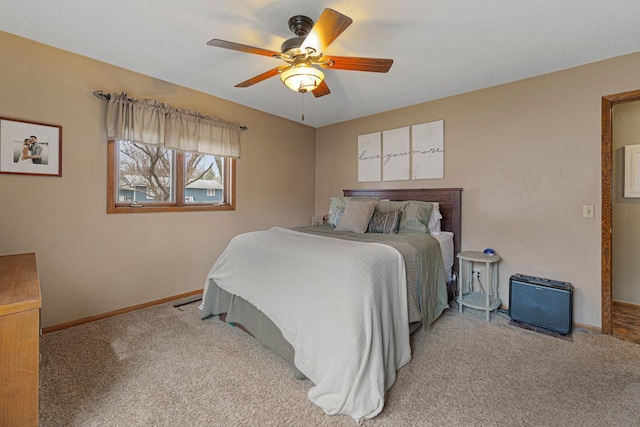 carpeted bedroom featuring baseboards and ceiling fan
