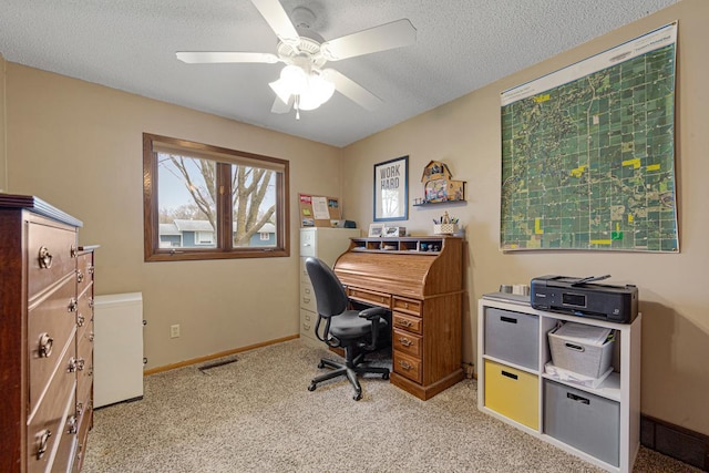 carpeted office featuring visible vents, baseboards, a textured ceiling, and ceiling fan