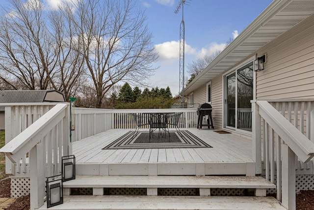 wooden terrace featuring a grill