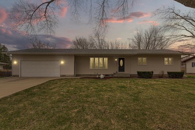 view of front of house with an attached garage, a front lawn, and concrete driveway