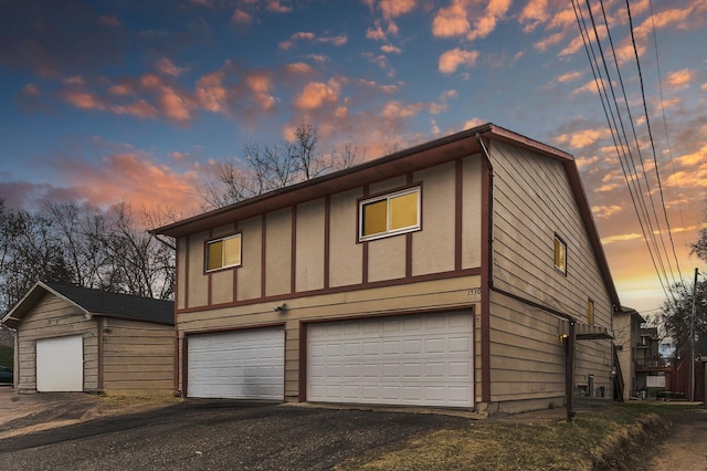 exterior space with aphalt driveway and an attached garage