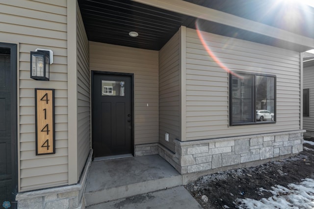 view of exterior entry with stone siding