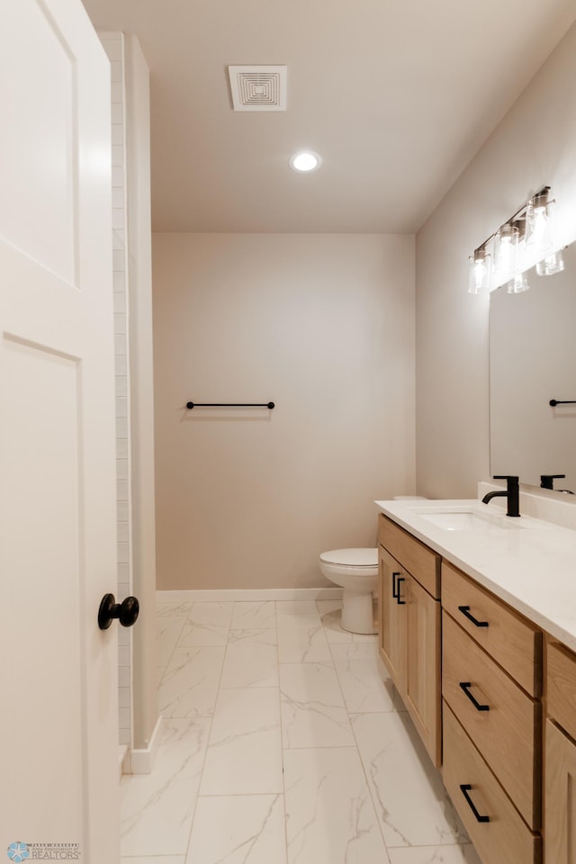 bathroom featuring vanity, baseboards, recessed lighting, visible vents, and marble finish floor