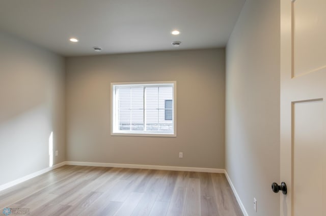 spare room with light wood-style flooring, recessed lighting, and baseboards