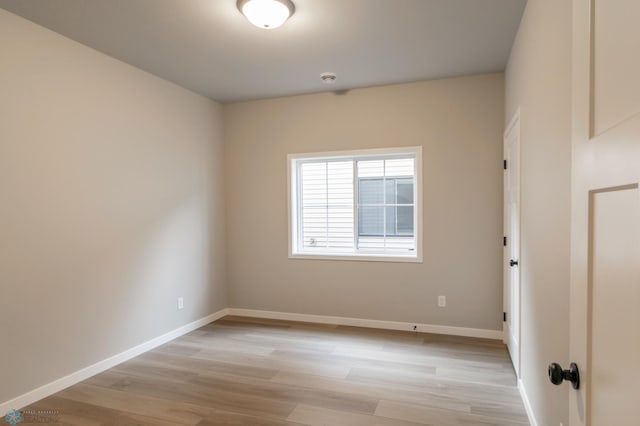 unfurnished room featuring light wood-style flooring and baseboards