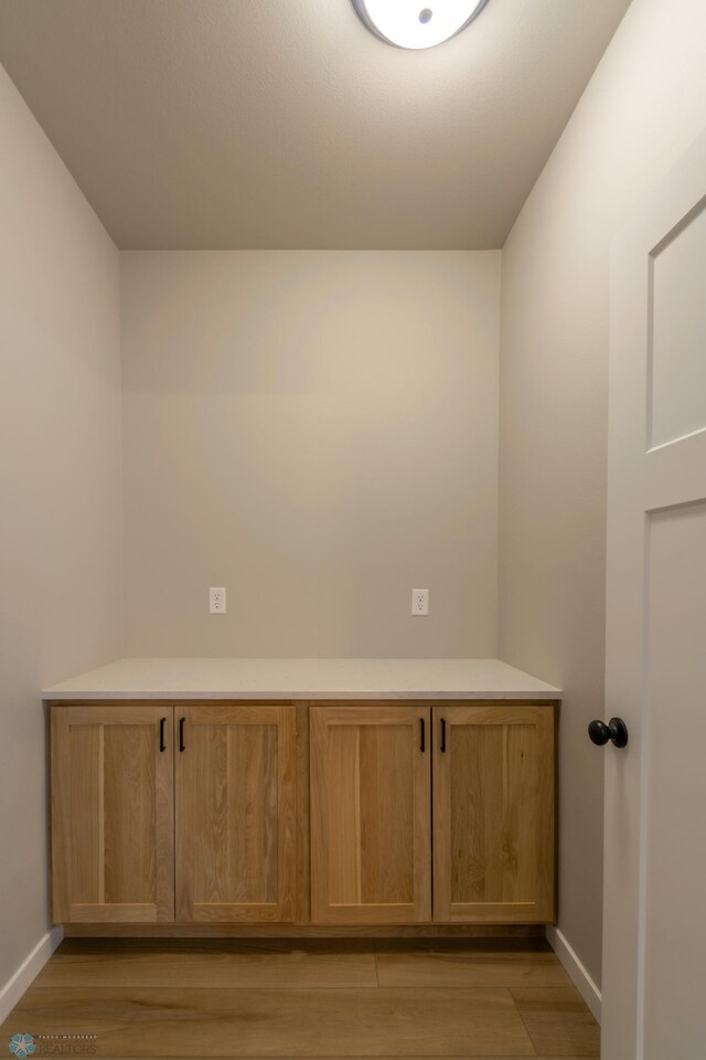 spare room with light wood-style flooring and baseboards