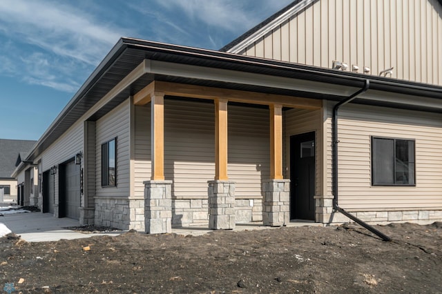 view of property exterior featuring board and batten siding and stone siding