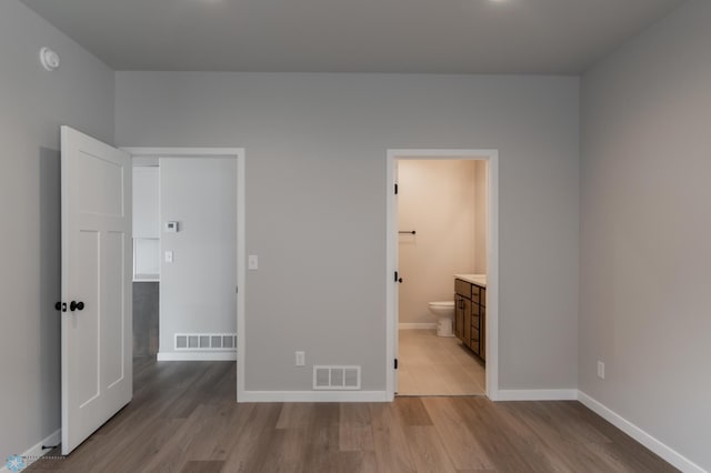 unfurnished bedroom with visible vents, baseboards, and light wood-style flooring