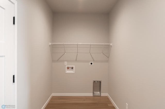 laundry area featuring hookup for an electric dryer, light wood-type flooring, baseboards, laundry area, and hookup for a washing machine