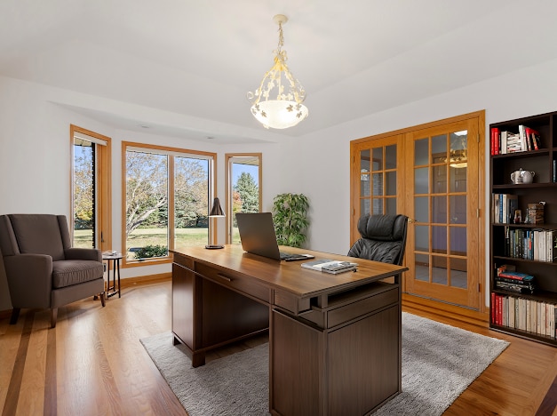 office space with french doors and light wood-type flooring