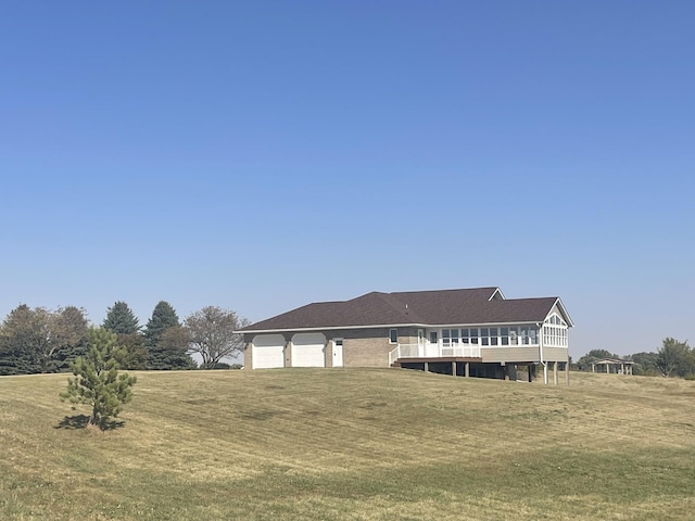 farmhouse inspired home featuring a front yard, an attached garage, and a deck