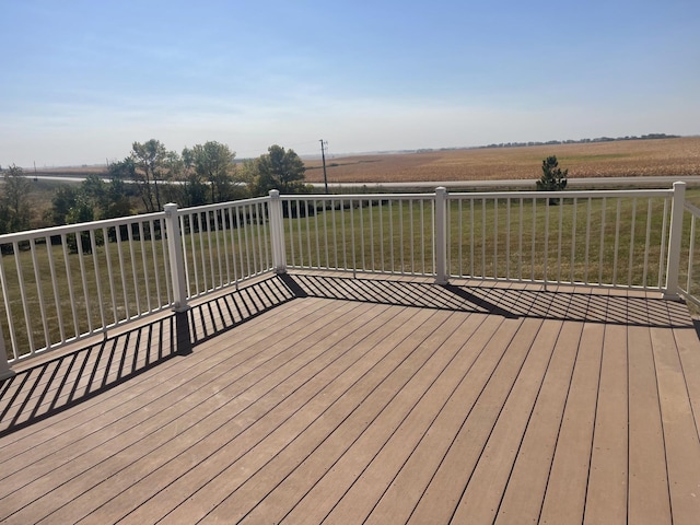 deck with a yard and a rural view