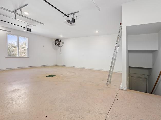 garage featuring recessed lighting and a garage door opener