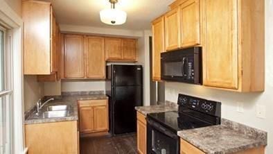 696 Hawthorne Ave E, Saint Paul, MN 55106 - kitchen featuring light brown cabinetry, a sink, and black appliances