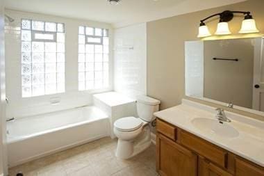 696 Hawthorne Ave E, Saint Paul, MN 55106 - bathroom featuring tile patterned flooring, toilet, and vanity