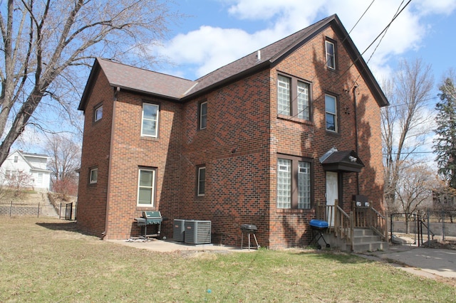 696 Hawthorne Ave E, Saint Paul, MN 55106 - view of home's exterior with roof with shingles, brick siding, fence, and a yard
