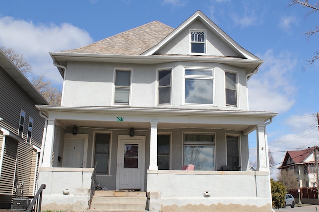 697 Cook Ave E, Saint Paul, MN 55106 - view of front of property with covered porch, stucco siding, and a shingled roof