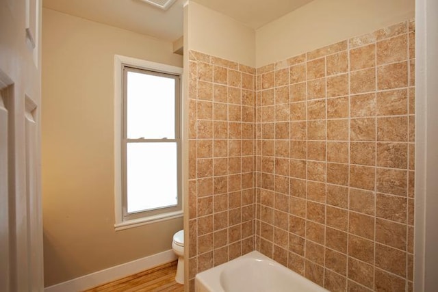 697 Cook Ave E, Saint Paul, MN 55106 - full bath featuring toilet, wood finished floors, baseboards, and shower / tub combination