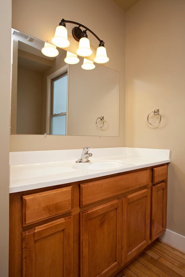 697 Cook Ave E, Saint Paul, MN 55106 - bathroom with vanity and wood finished floors