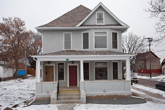 697 Cook Ave E, Saint Paul, MN 55106 - american foursquare style home featuring covered porch, stucco siding, and roof with shingles