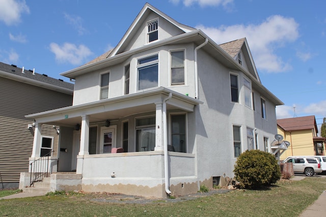 697 Cook Ave E, Saint Paul, MN 55106 - american foursquare style home featuring covered porch and stucco siding