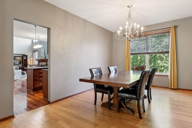20413 Everton Trl N, Forest Lake, MN 55025 - dining room with baseboards, light wood finished floors, and a chandelier