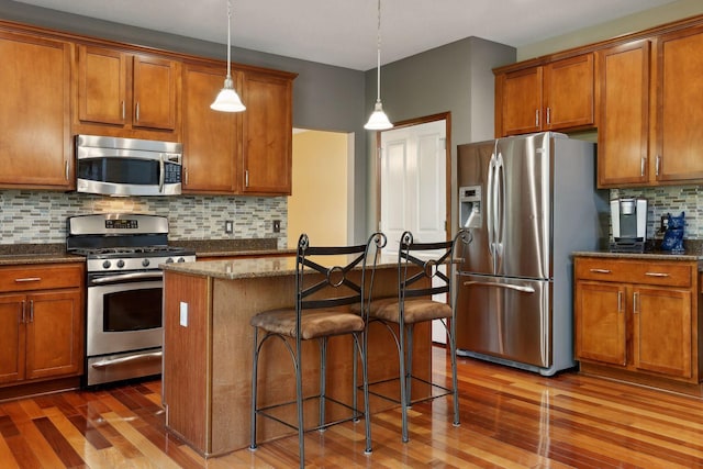 20413 Everton Trl N, Forest Lake, MN 55025 - kitchen with brown cabinetry, wood finished floors, and stainless steel appliances