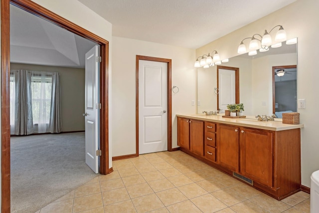 20413 Everton Trl N, Forest Lake, MN 55025 - full bath featuring double vanity, ceiling fan, a sink, and tile patterned flooring