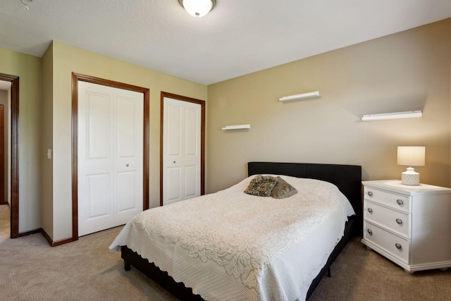 20413 Everton Trl N, Forest Lake, MN 55025 - carpeted bedroom featuring baseboards and two closets