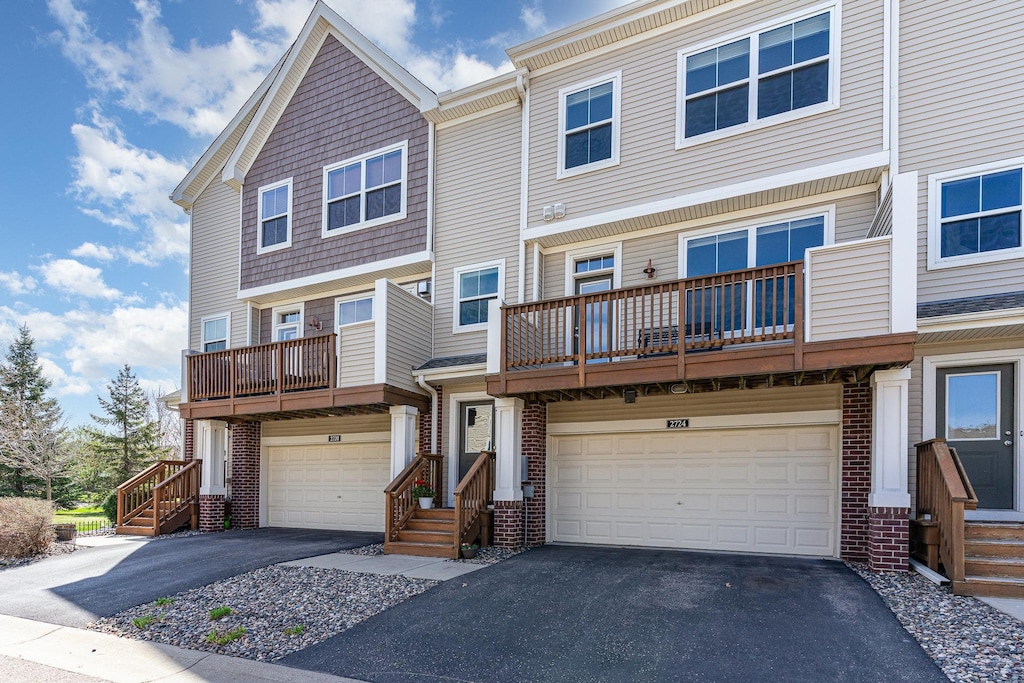 2724 135th St W, Rosemount, MN 55068 - view of property with an attached garage, aphalt driveway, and a balcony