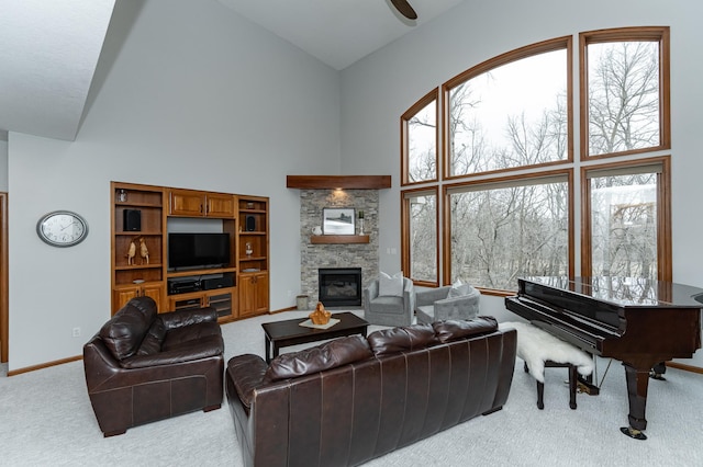 1125 Riverwood Dr SW, Oronoco, MN 55960 - living room with light colored carpet, high vaulted ceiling, a stone fireplace, and baseboards