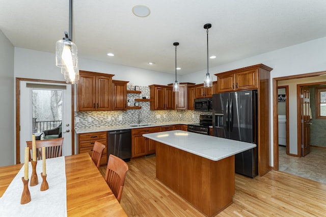 1125 Riverwood Dr SW, Oronoco, MN 55960 - kitchen with appliances with stainless steel finishes, open shelves, a sink, brown cabinets, and tasteful backsplash