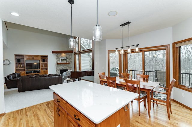 1125 Riverwood Dr SW, Oronoco, MN 55960 - kitchen with light wood-style floors, plenty of natural light, a stone fireplace, and recessed lighting