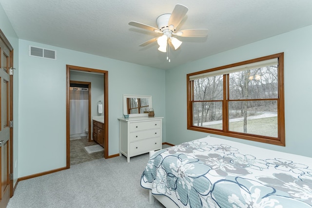 1125 Riverwood Dr SW, Oronoco, MN 55960 - bedroom with light carpet, baseboards, ceiling fan, and ensuite bathroom