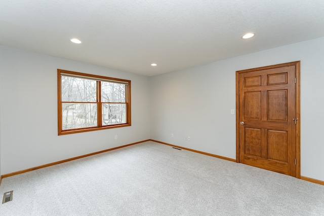 1125 Riverwood Dr SW, Oronoco, MN 55960 - unfurnished room featuring light colored carpet, baseboards, and recessed lighting