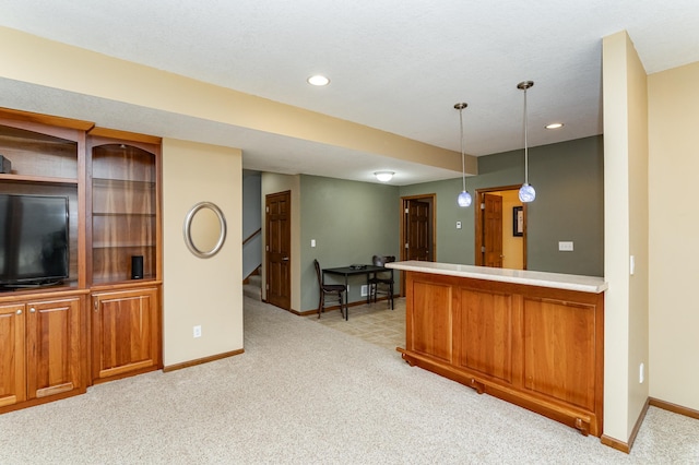 1125 Riverwood Dr SW, Oronoco, MN 55960 - kitchen with baseboards, brown cabinets, light colored carpet, hanging light fixtures, and recessed lighting