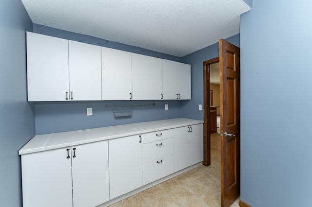 1125 Riverwood Dr SW, Oronoco, MN 55960 - kitchen featuring light countertops, white cabinets, and a textured ceiling