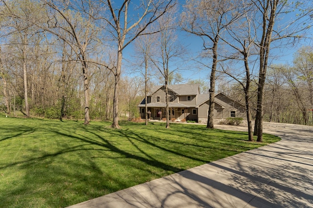 1125 Riverwood Dr SW, Oronoco, MN 55960 - view of green lawn featuring a porch and concrete driveway