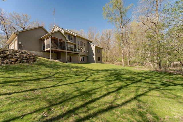1125 Riverwood Dr SW, Oronoco, MN 55960 - back of house featuring a sunroom, a lawn, ceiling fan, and a deck