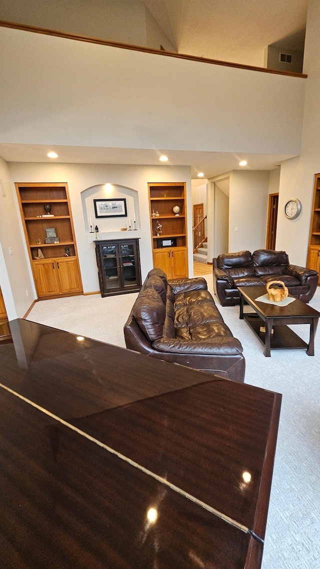 1125 Riverwood Dr SW, Oronoco, MN 55960 - living room featuring carpet flooring, built in shelves, stairway, and recessed lighting