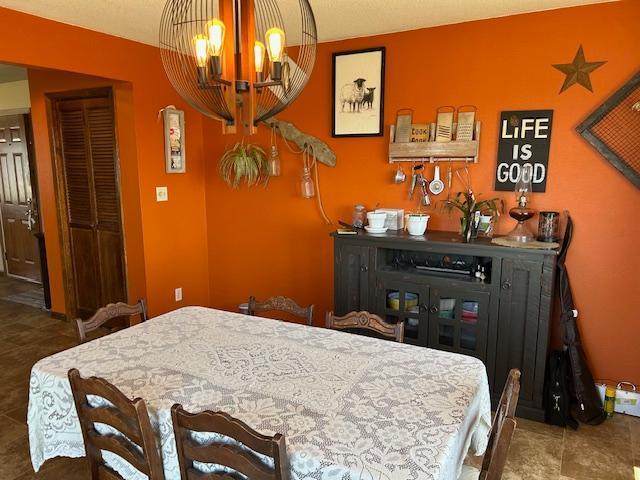 bedroom featuring a notable chandelier and tile patterned flooring