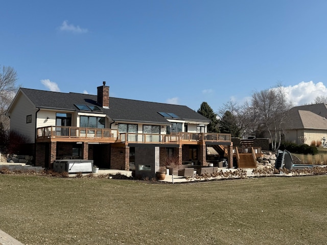 back of house featuring an outdoor living space, a chimney, a yard, a patio, and a wooden deck