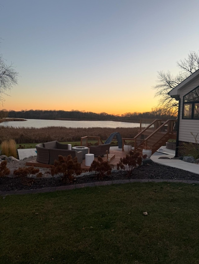 view of yard with a fire pit and a water view