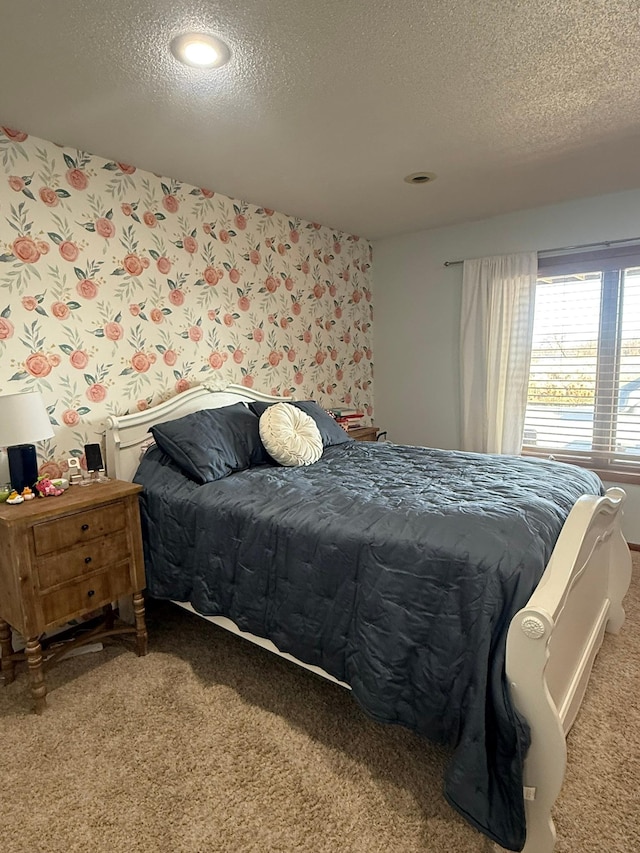 bedroom featuring carpet floors and a textured ceiling